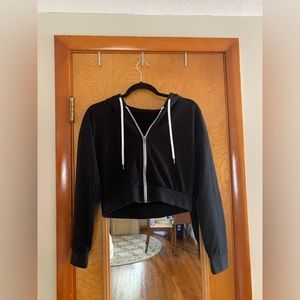 Black cropped zip-up jacket with hood.